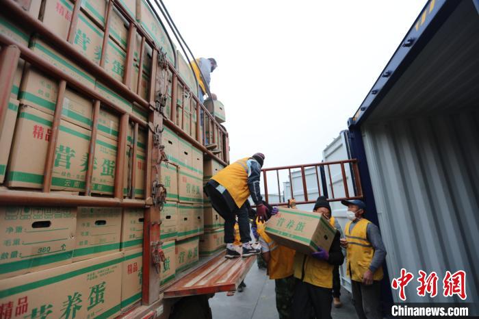 圖為鐵路裝卸作業(yè)人員正在將云南特色農(nóng)產(chǎn)品裝入集裝箱?！詈?攝